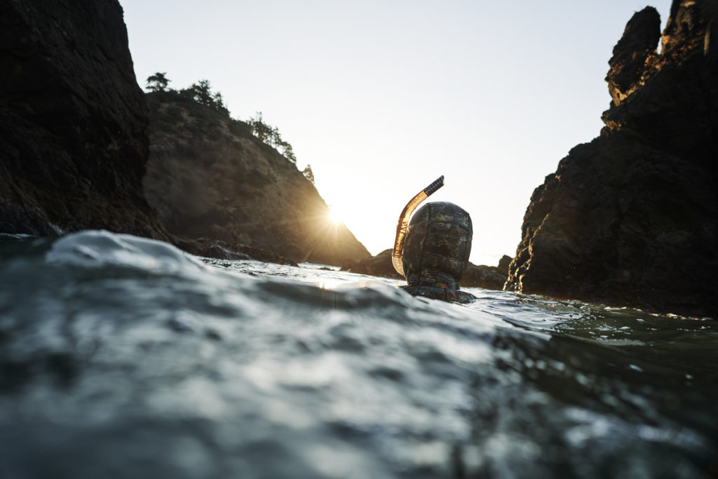 Tom Calvanese treading water in the ocean near Port Orford while snorkeling in a cove almost completely devoid of kelp.